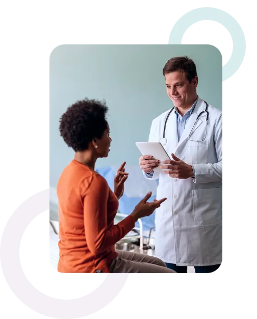 A doctor reviewing treatment options with a patient on a tablet