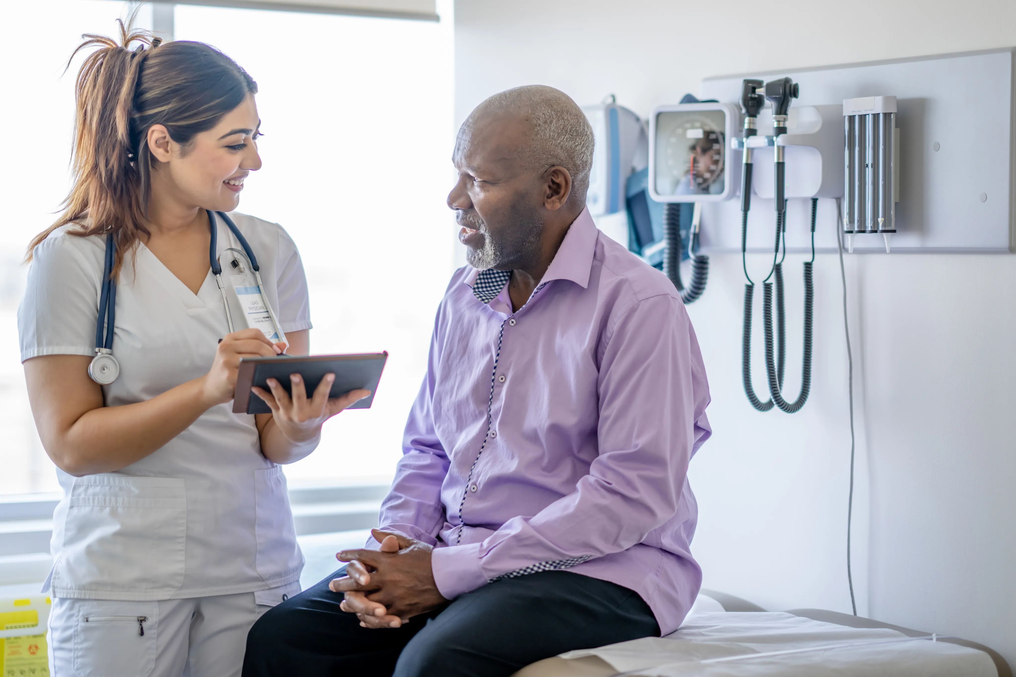 A nurse talking with a patient during an appointment
