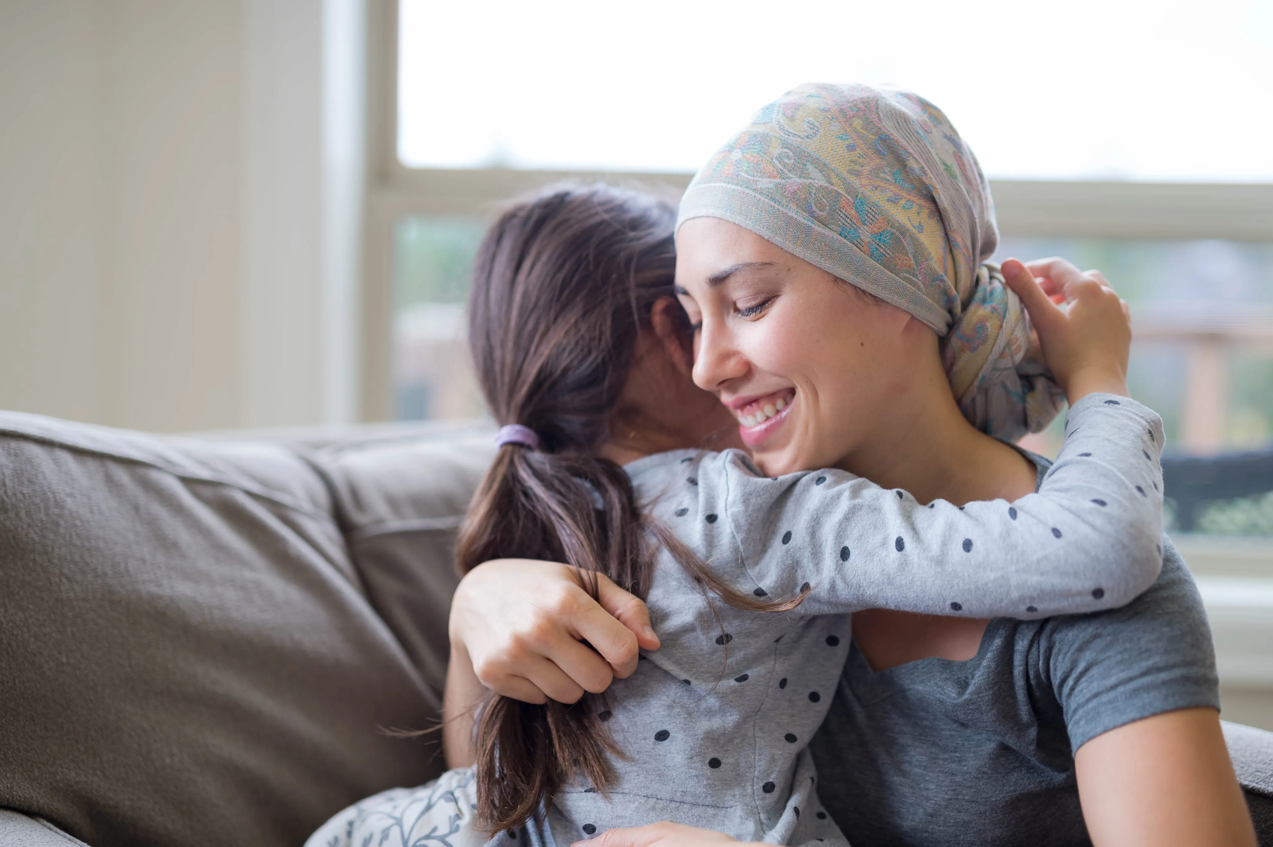 A mother and daughter sharing a hug at home